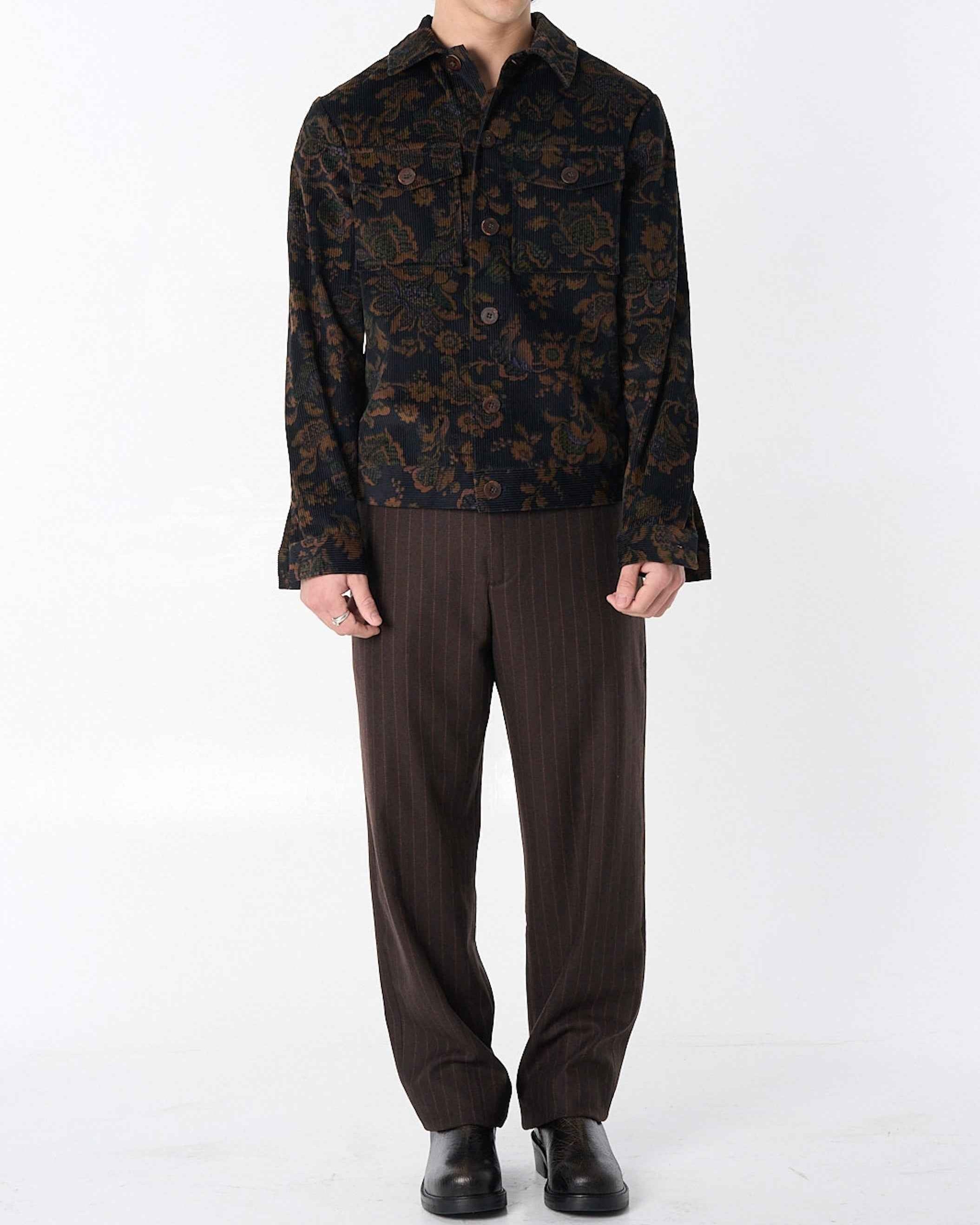 Dean" jacket in black and brown calico floral corduroy with relaxed boxy fit, shown on model in three-quarter view