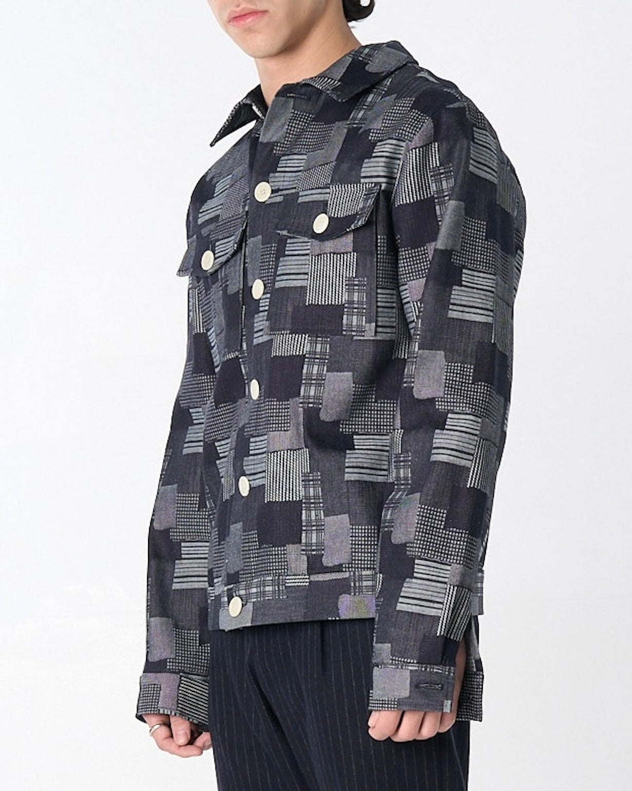 Dean Jacket in dark denim patchwork jacquard with mixed weave textures, relaxed boxy fit, shown on model from front.