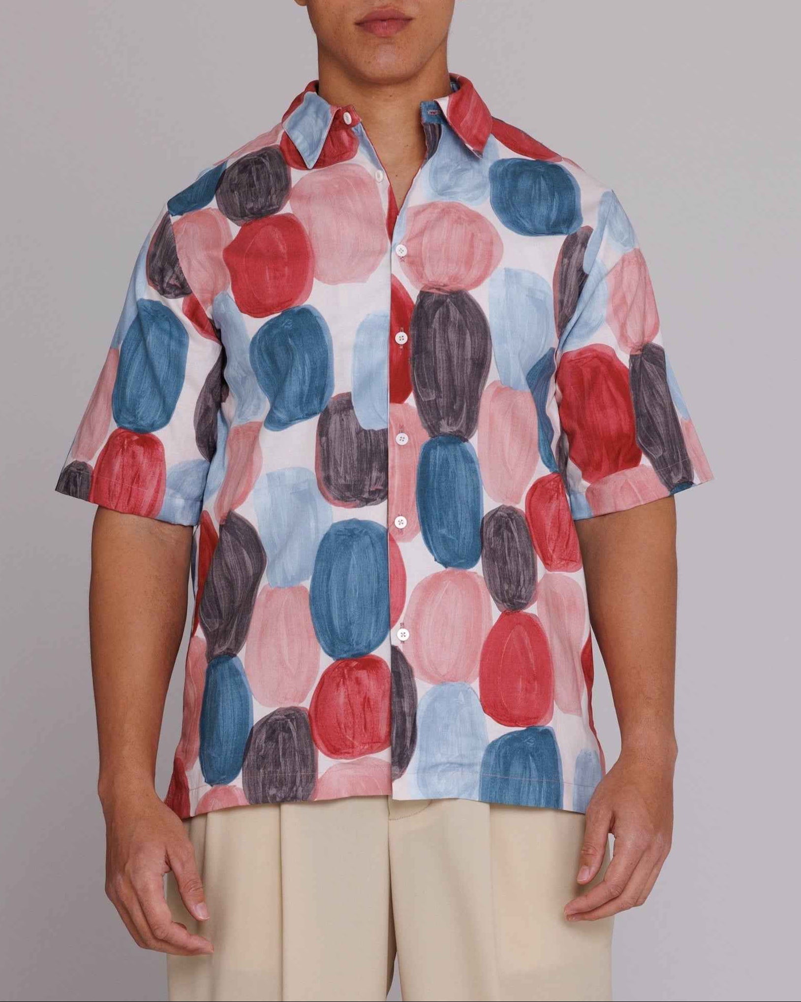 Graphia New York "Flowers" button-up shirt in red, blue, and black dot print on model, loose fit, cotton poplin.