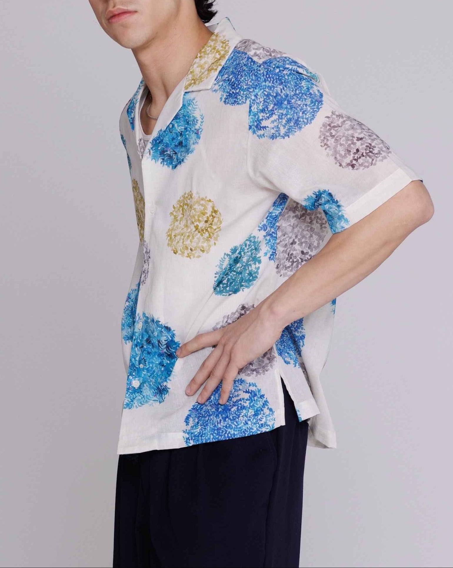 Arnaz Resort Shirt in blue and gold watercolor leaves print, cropped wide fit, worn by model showing front view with side seam openings.