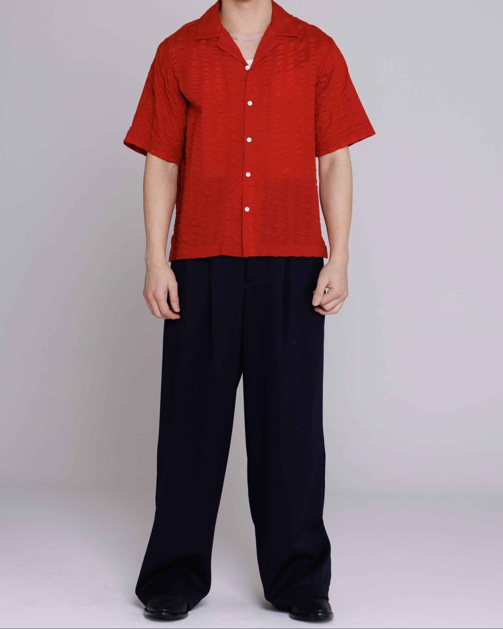 Arnaz Resort Shirt in cherry red seersucker with wide bold stripes, cropped fit, shown on model from waist up.