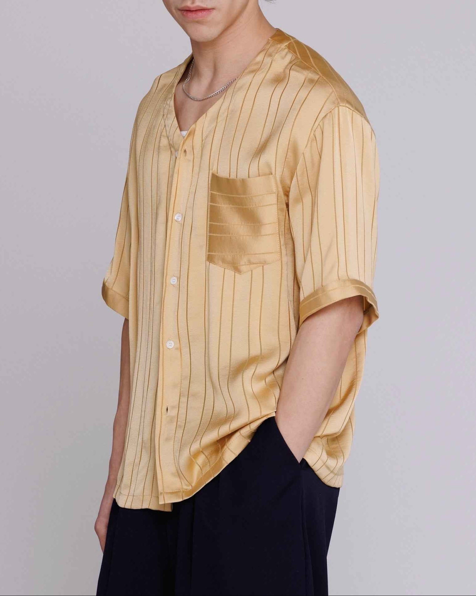 Valenzuela Baseball Collar Shirt in Gold Satin Stripe worn by model, showing cupro blend georgette fabric with dobby stripe texture and relaxed fit.