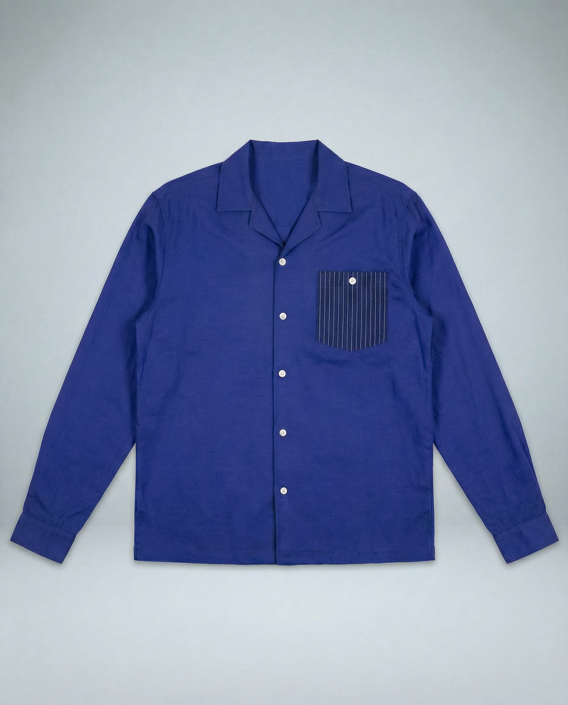 Royal blue and white striped convertible-collar shirt in cotton cupro linen twill, relaxed contemporary fit, displayed on model.
