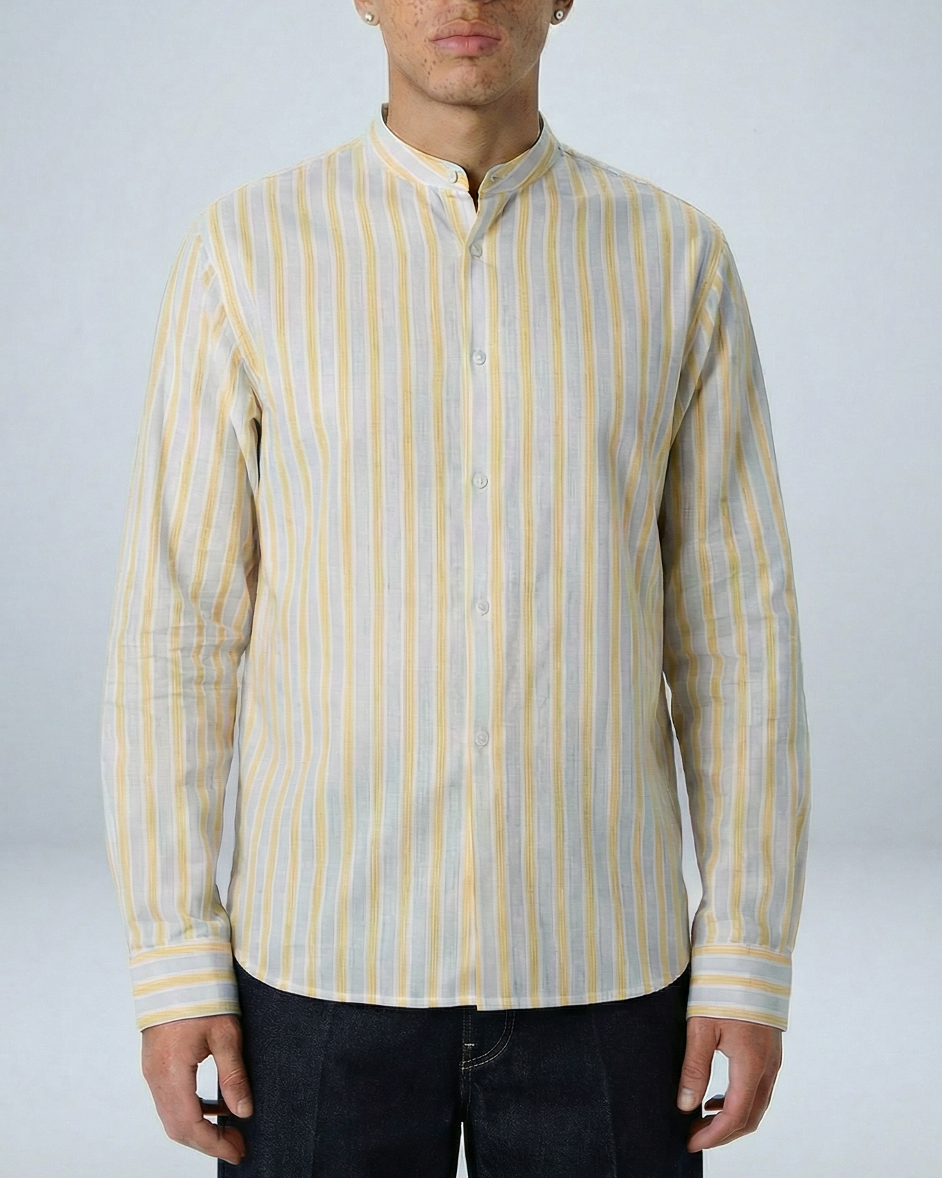 Liam band collar shirt in cream and yellow stripe, relaxed fit, worn untucked on model against neutral background.