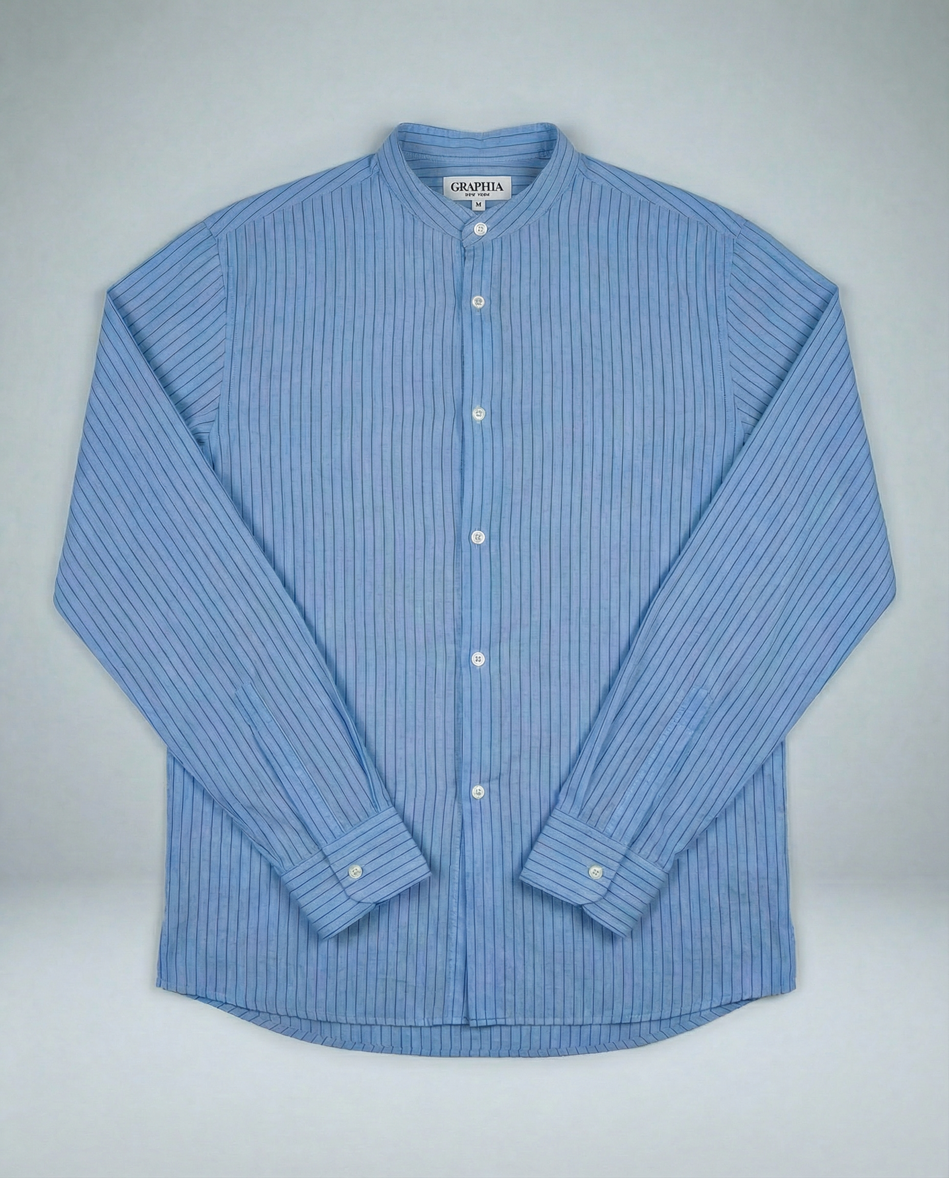 Liam band collar shirt in light blue and blue stripe, lightweight cotton voile with subtle crinkle texture, relaxed fit shown on model.