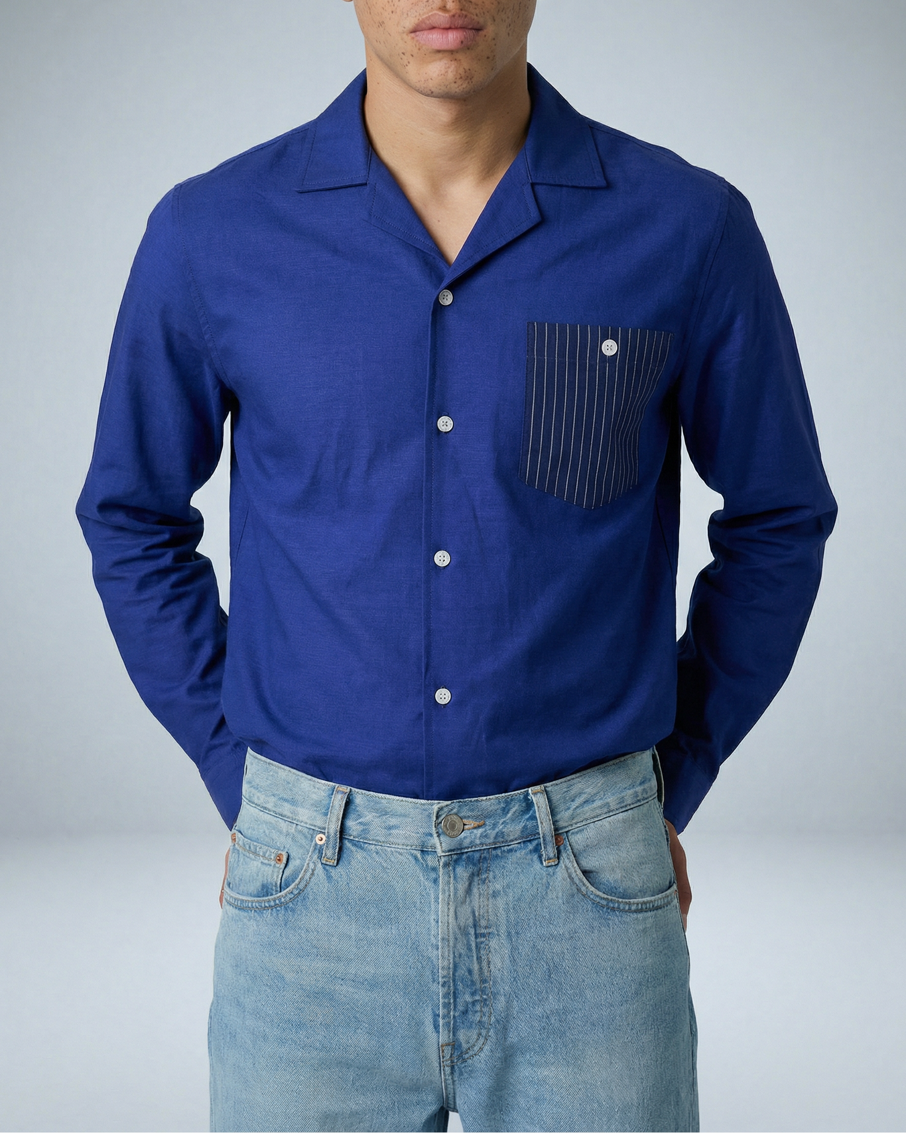 Model wearing Arenas royal blue and white striped shirt with convertible collar, tucked in, facing forward in close-up shot.