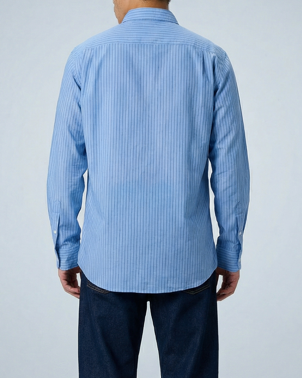 Man wearing light blue and blue striped band collar shirt, shown from behind in full-length pose with hands at sides, displaying relaxed fit and crinkle cotton voile fabric.