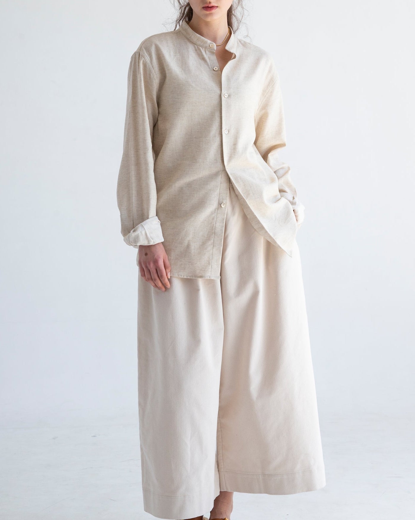 Liam band collar vintage cream long sleeve shirt in cotton linen, relaxed fit, modeled with button cuffs and minimalist neckline.