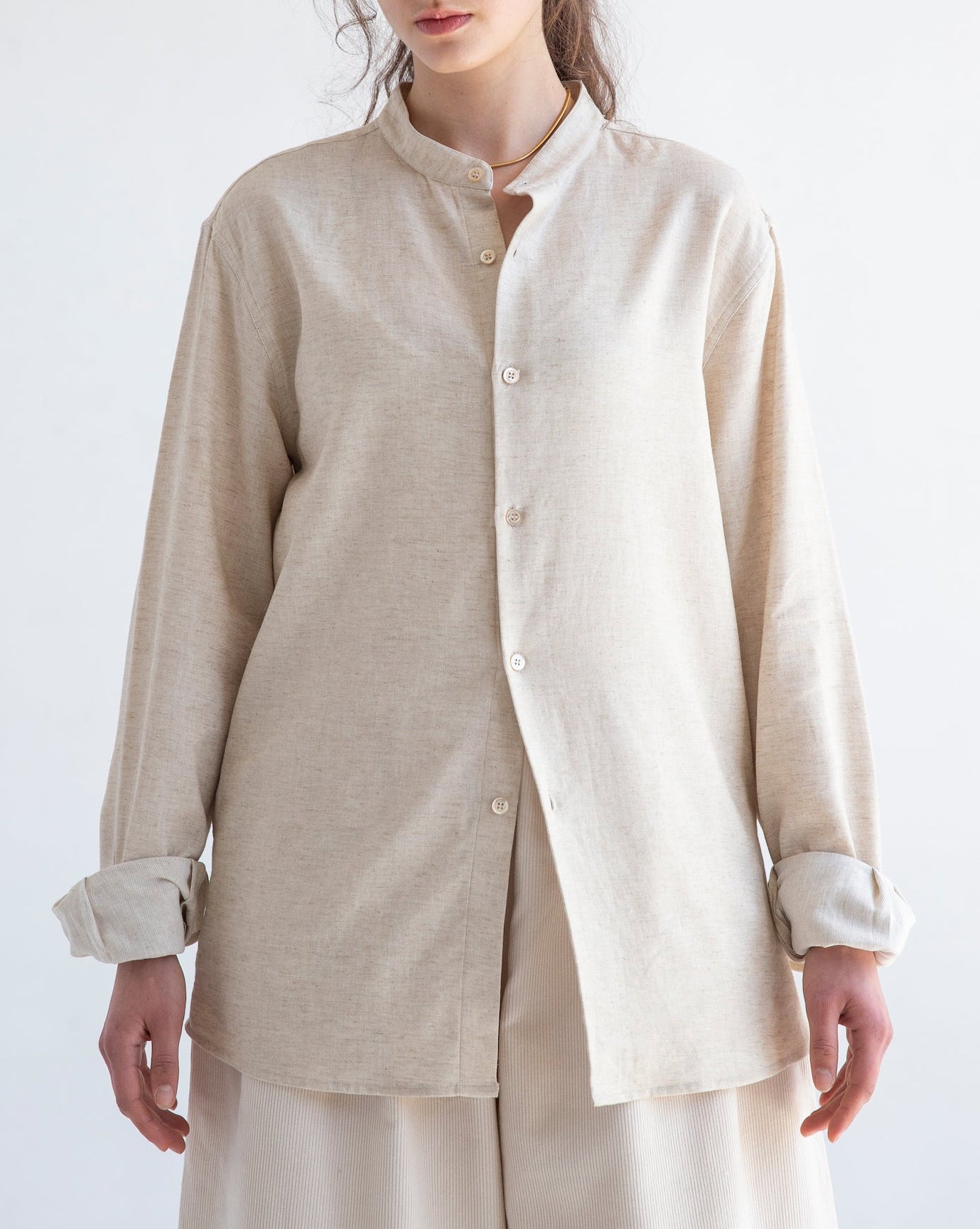 Liam band collar shirt in vintage cream, relaxed fit cotton linen, shown on model with long sleeves and button cuffs.