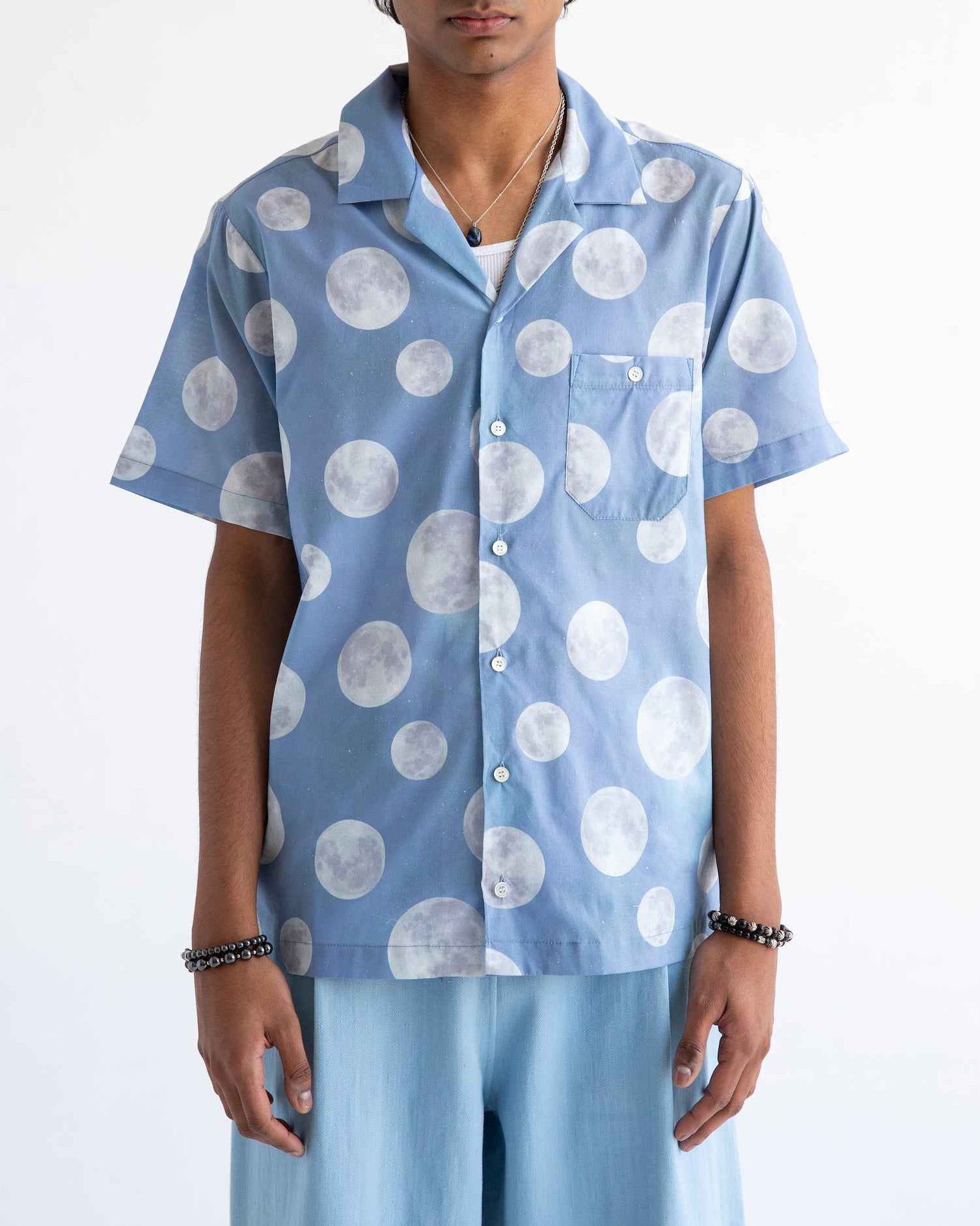 Desi short sleeve resort shirt in blue Daytime Moon print, Cuban collar, lightweight cotton voile, relaxed fit with side slits.
