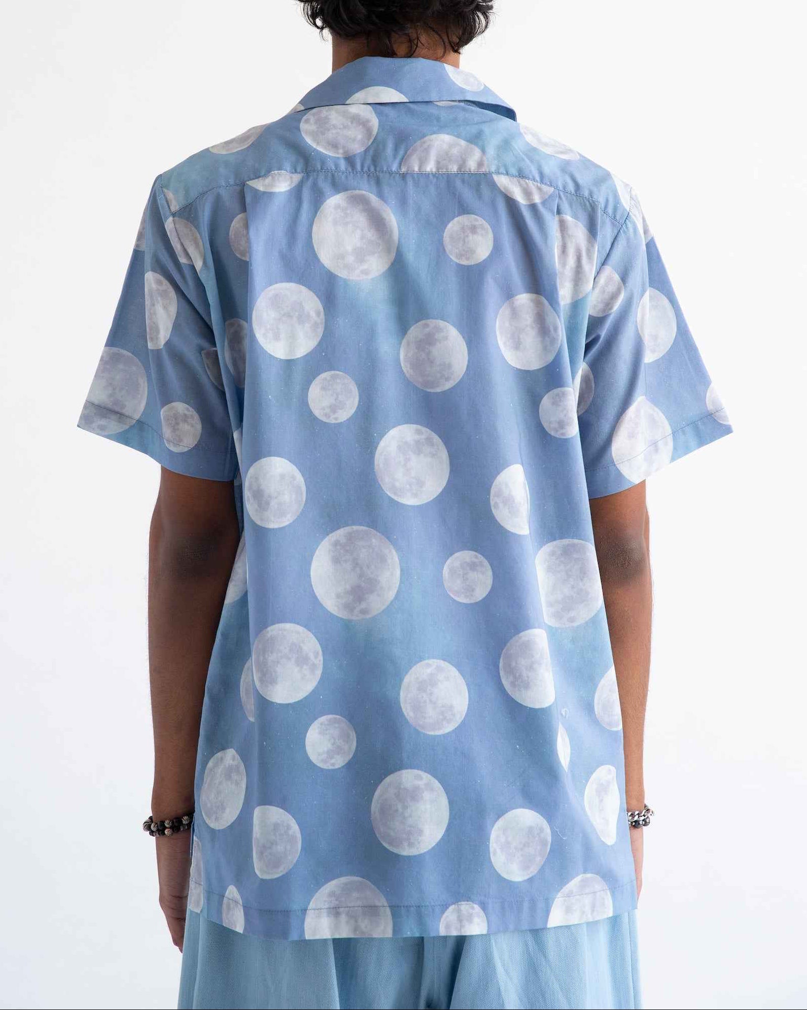 Desi short sleeve resort shirt in blue Daytime Moon print, Cuban collar, lightweight cotton voile, relaxed fit with side slits.