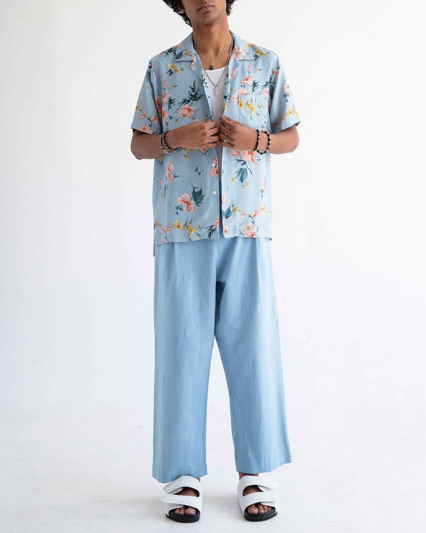 Desi short sleeve resort shirt in light blue Ukiyoe Hibiscus print, rayon poplin camp collar, displayed on model.