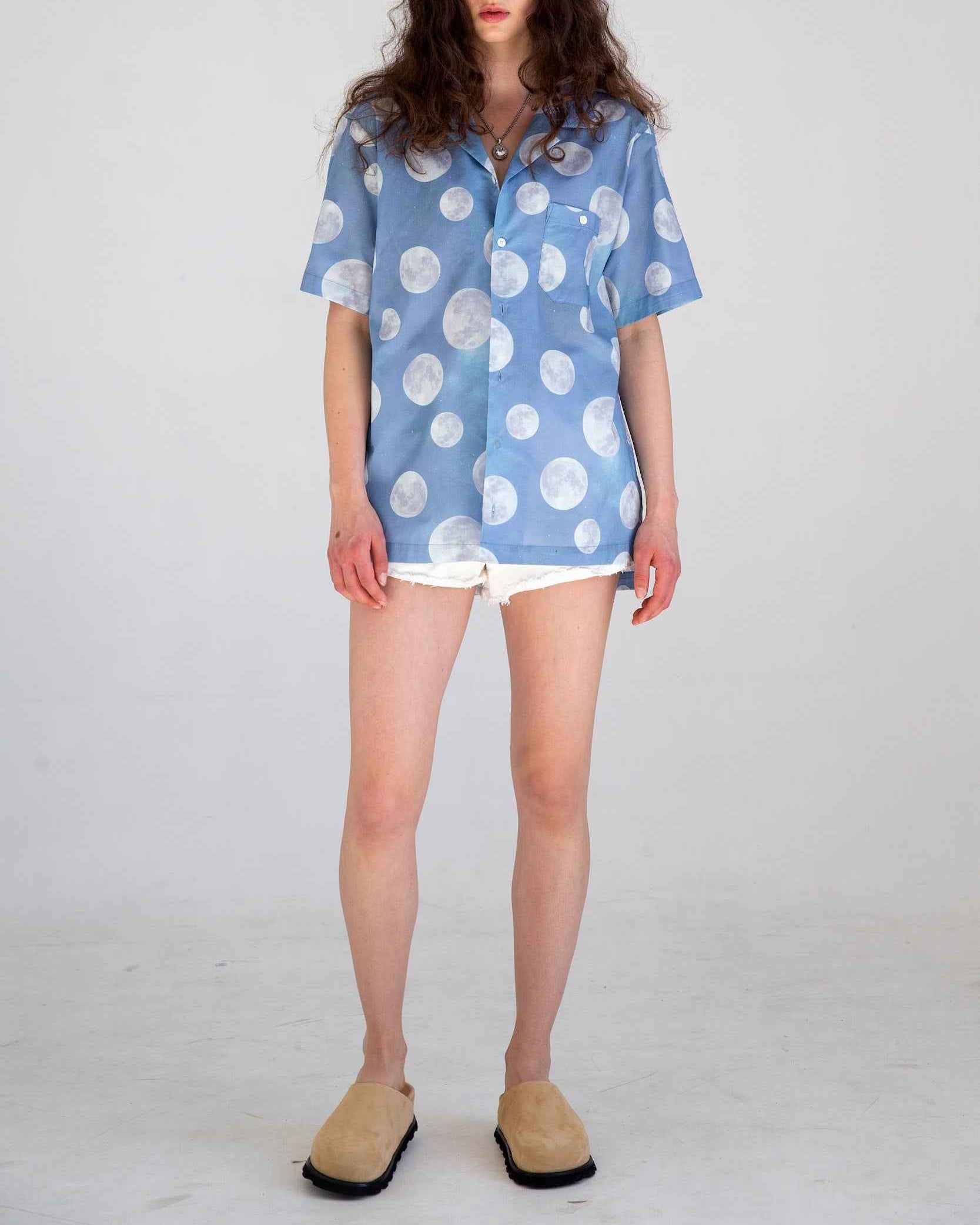 Desi short sleeve resort shirt in light blue Daytime Moon print, Cuban collar, lightweight cotton voile, relaxed fit with side slits.