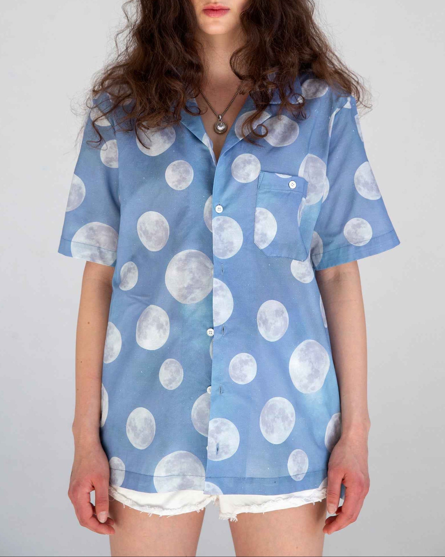 Desi short sleeve resort shirt in blue Daytime Moon print, Cuban collar, lightweight cotton voile, relaxed fit with side slits.
