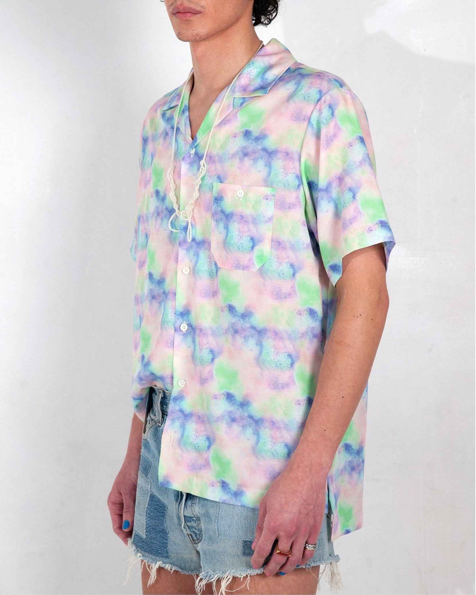 Desi camp collar shirt in blue dream pop print, relaxed resort fit, worn untucked, cotton-tencel fabric with vibrant artistic print.