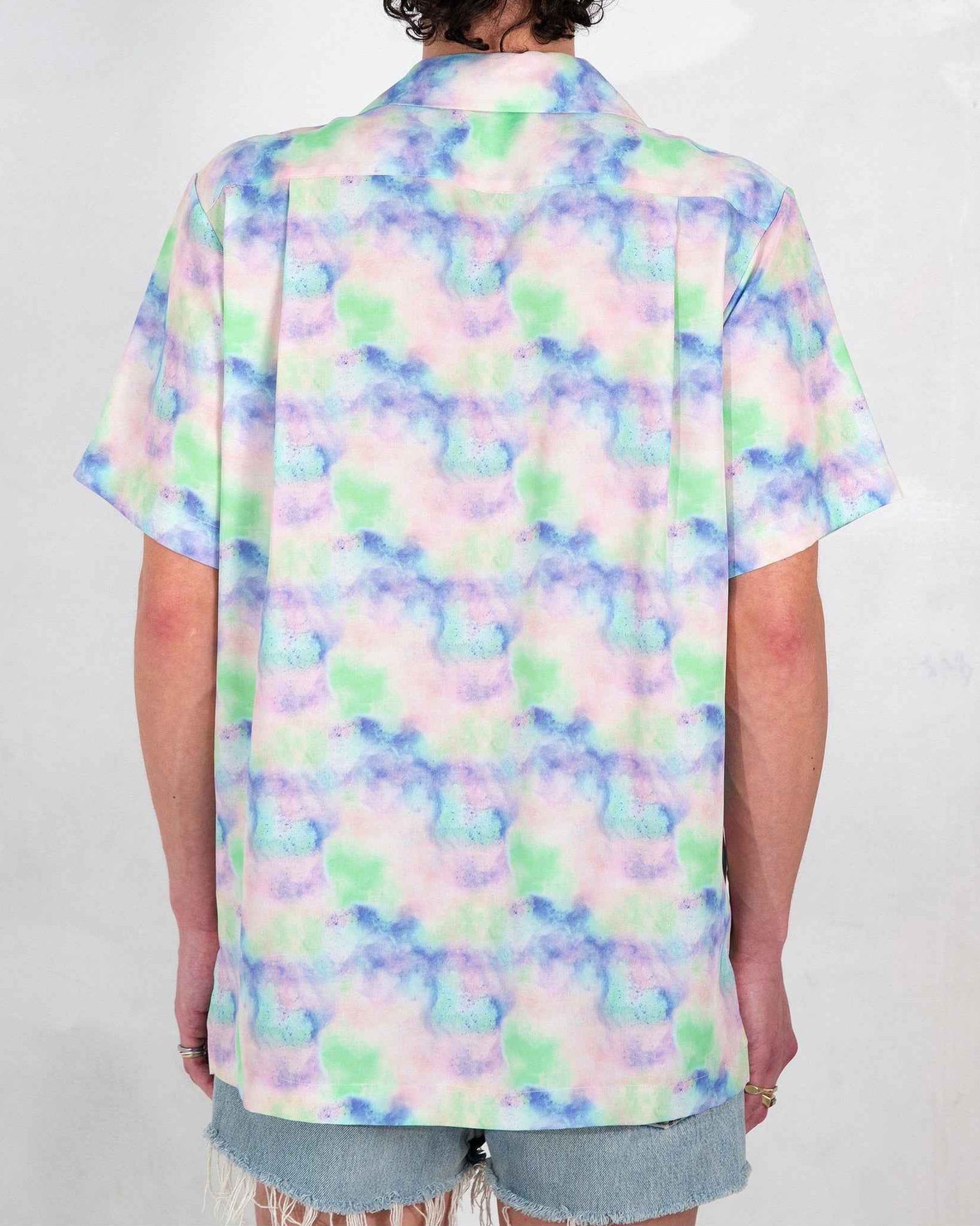 Desi Camp Collar shirt in Blue Dream Pop Print worn untucked, relaxed resort fit, short sleeves, vibrant artistic print on lightweight cotton.