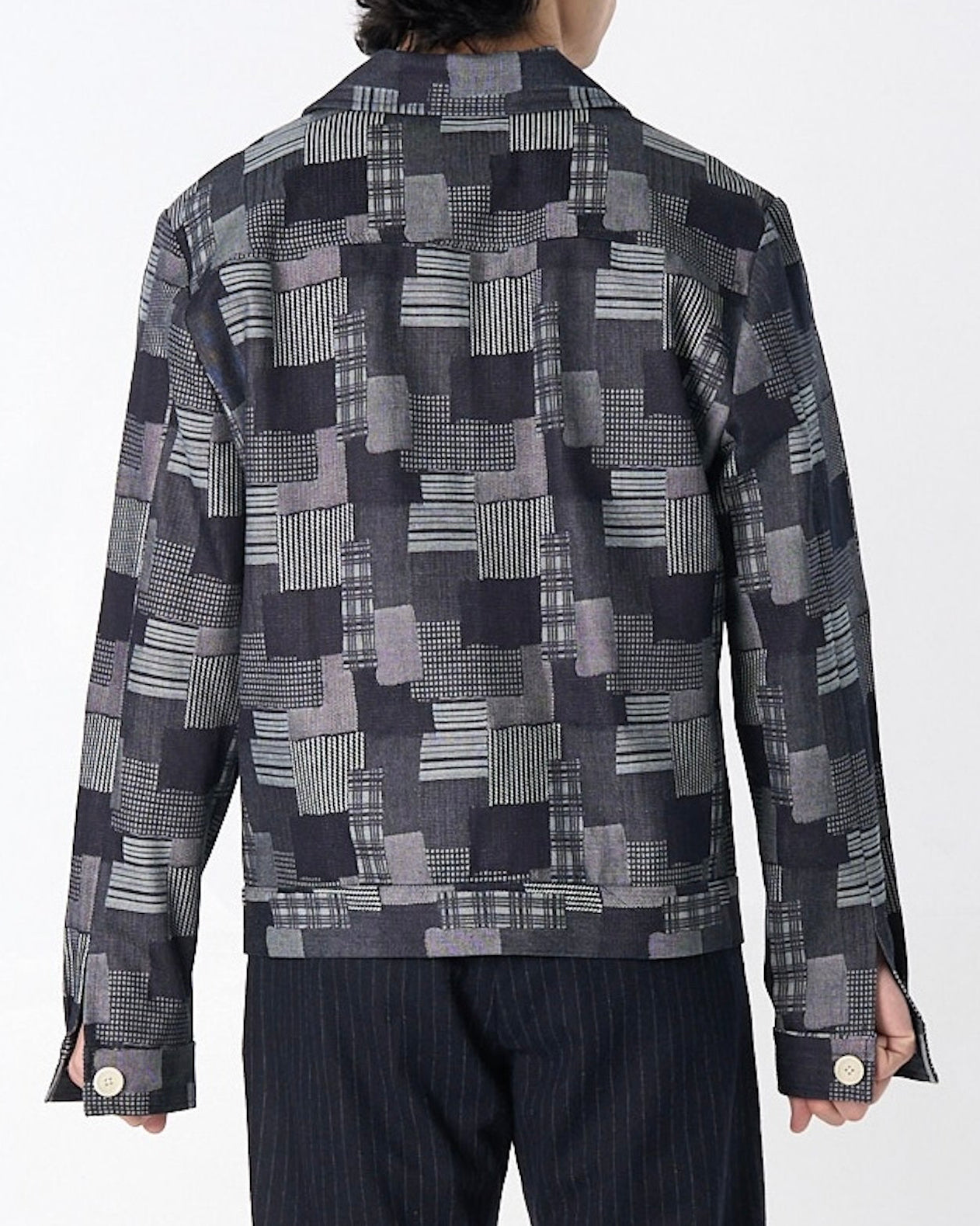 Dark denim patchwork jacquard Dean Jacket with relaxed boxy fit, displayed on model showing fabric texture and construction details.