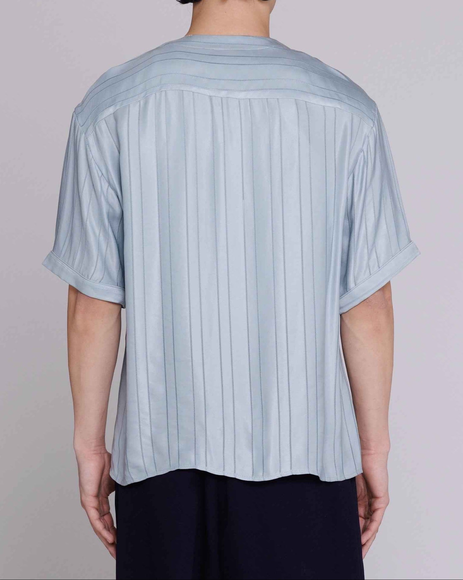 Valenzuela baseball collar shirt in blue satin stripe cupro blend, relaxed fit, front chest pocket visible, model wearing medium.