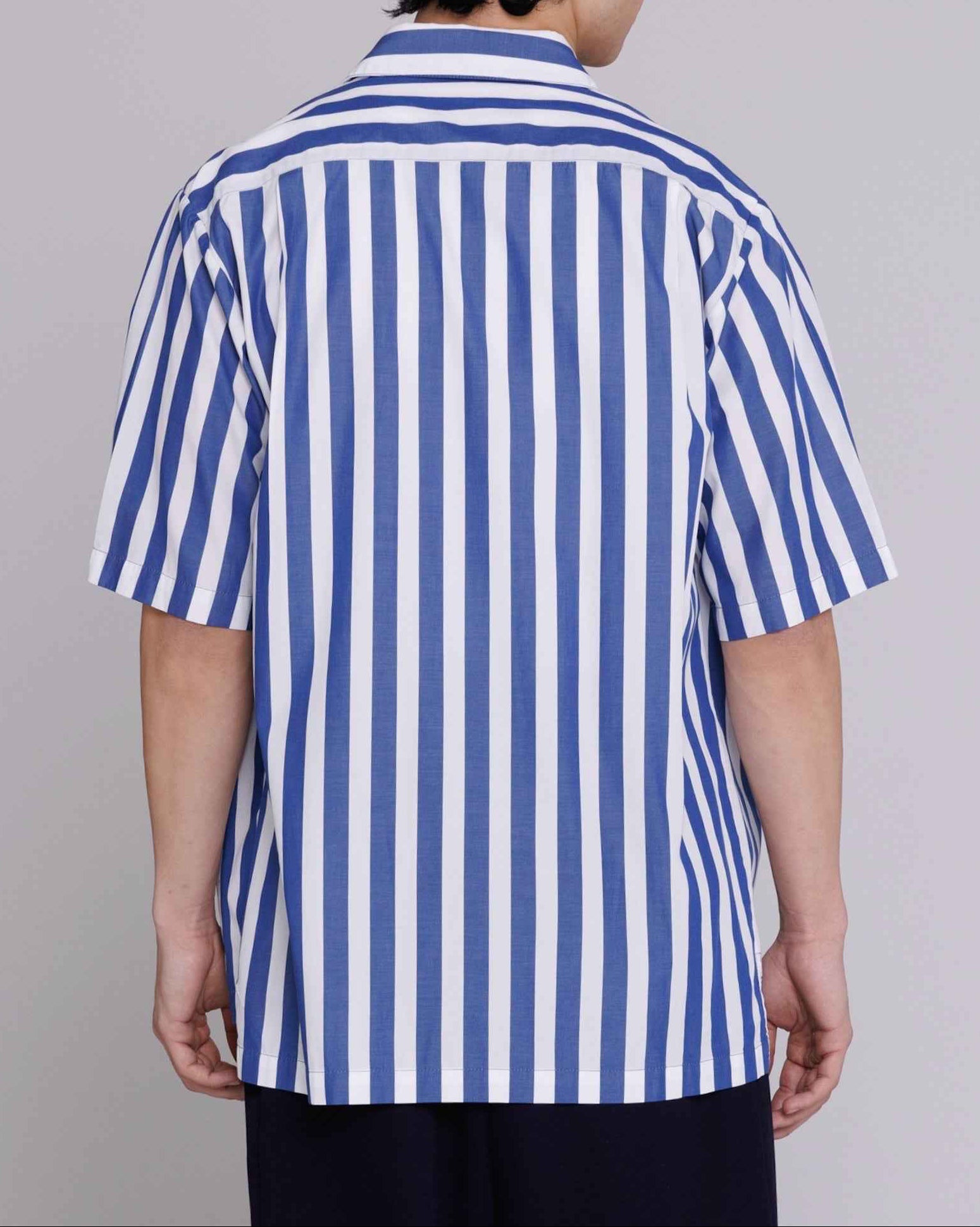 Flowers button-up shirt in blue and white bar stripes, relaxed fit cotton poplin, worn by model in medium.