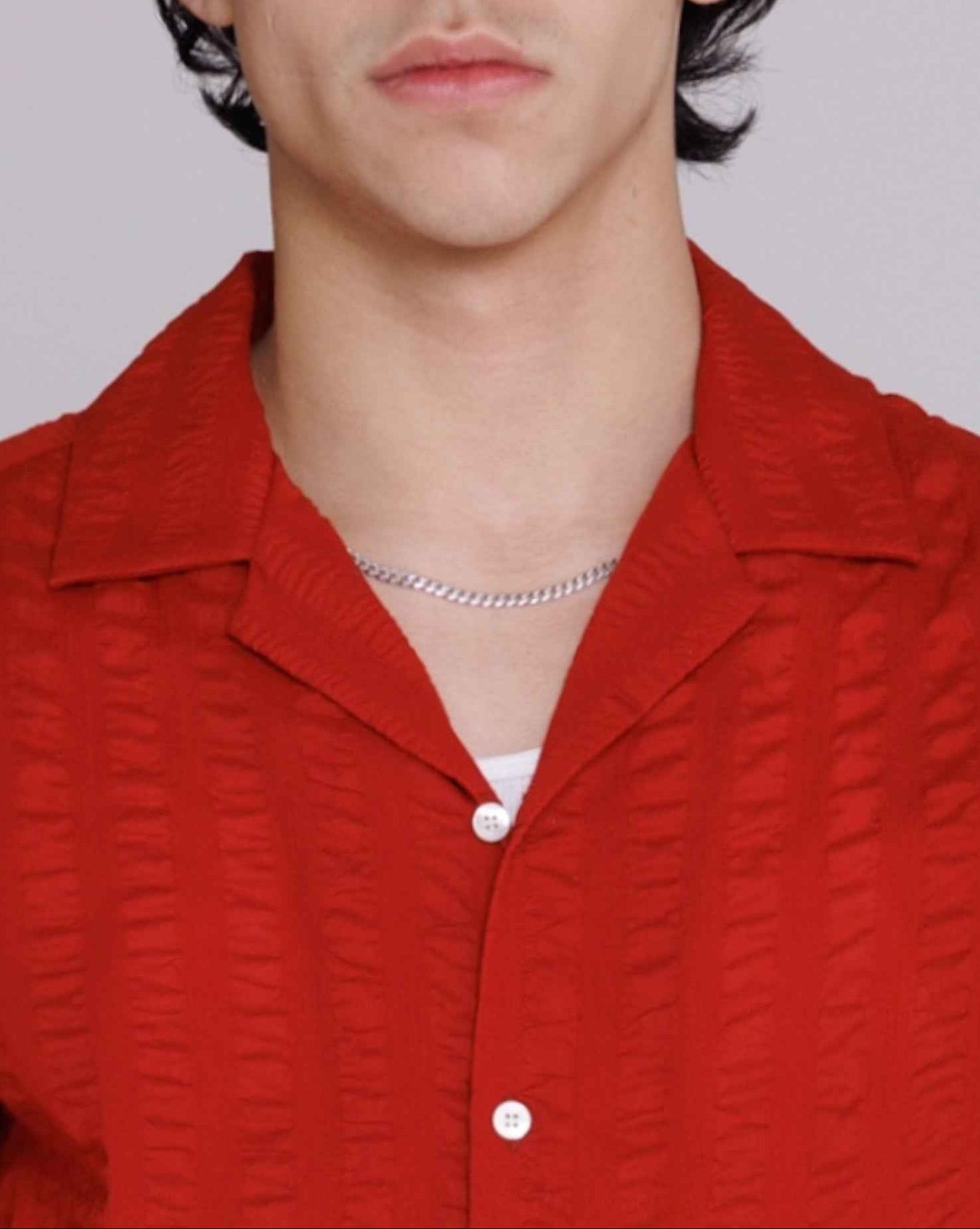 Arnaz Resort Shirt in cherry red seersucker with wide textured stripes, cropped fit, displayed on model from front.