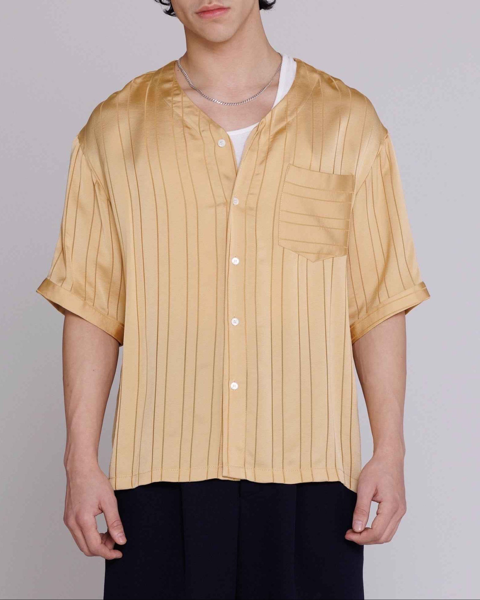 Valenzuela baseball collar shirt in gold satin stripe cupro blend georgette with dobby texture, relaxed fit, modeled full-length.