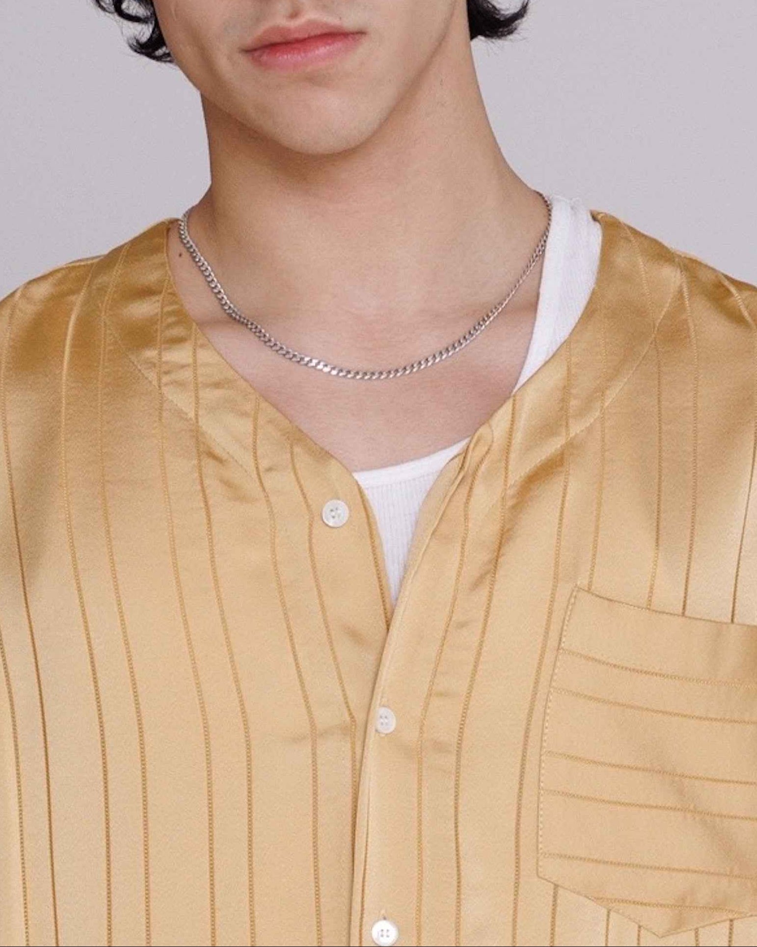 Valenzuela baseball collar shirt in gold satin stripe cupro georgette with dobby texture, relaxed fit, modeled front view.
