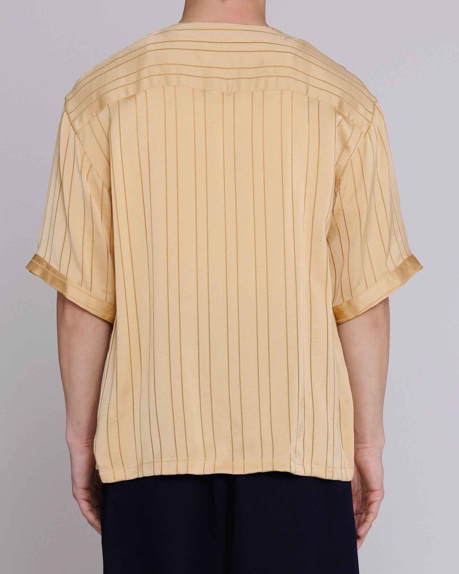 Valenzuela baseball collar shirt in gold satin stripe cupro blend georgette with dobby texture, worn by model in relaxed fit.