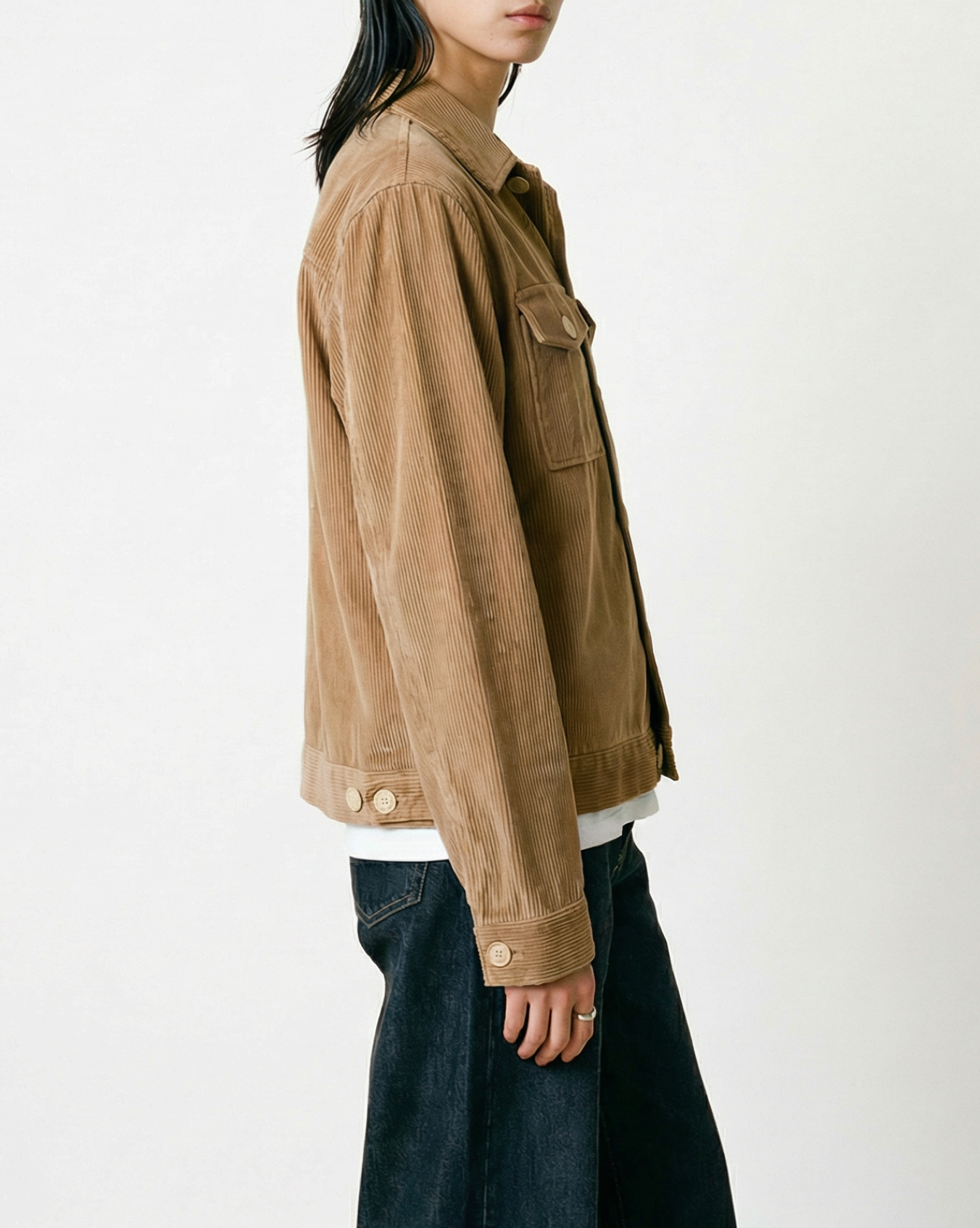 Dean Jacket in Fawn Brown 8-wale corduroy worn by woman in side profile with dark jeans, showing relaxed boxy fit and hip-length silhouette against white background.