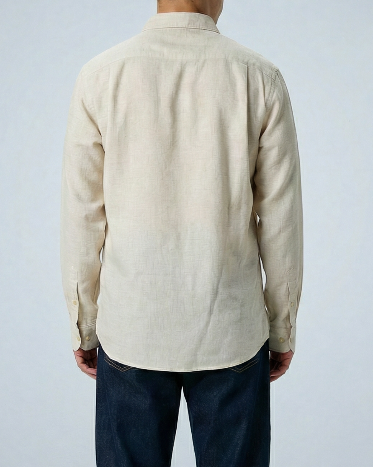 Liam band collar shirt in vintage cream linen cotton, relaxed fit, worn untucked with button cuffs, displayed on model.