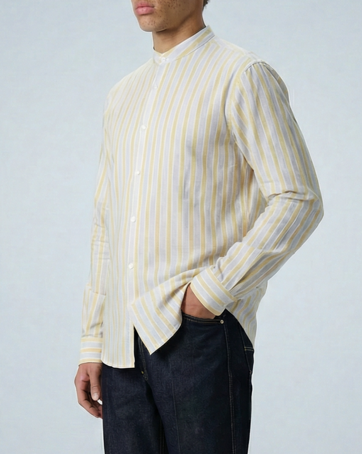 Liam cream and yellow striped long sleeve shirt with band collar on model, showing relaxed fit and textured slub cotton fabric.