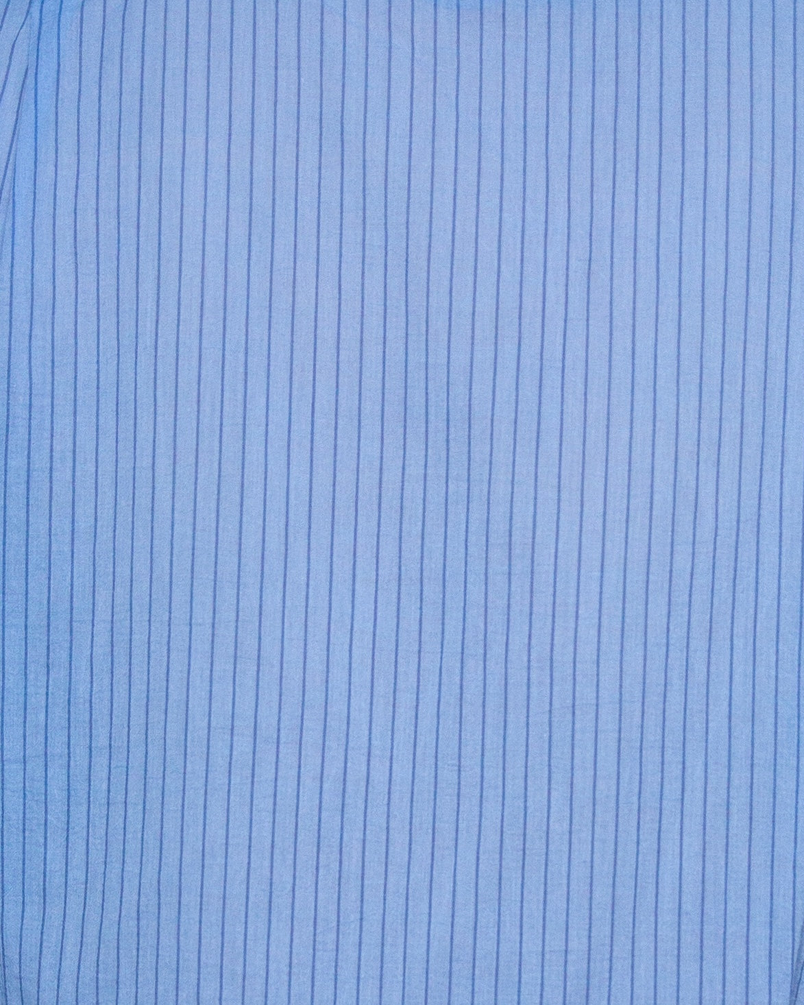 Liam band collar shirt in light blue and blue stripe, relaxed fit, shown on model in three-quarter view highlighting the lightweight cotton voile fabric and crinkle texture.