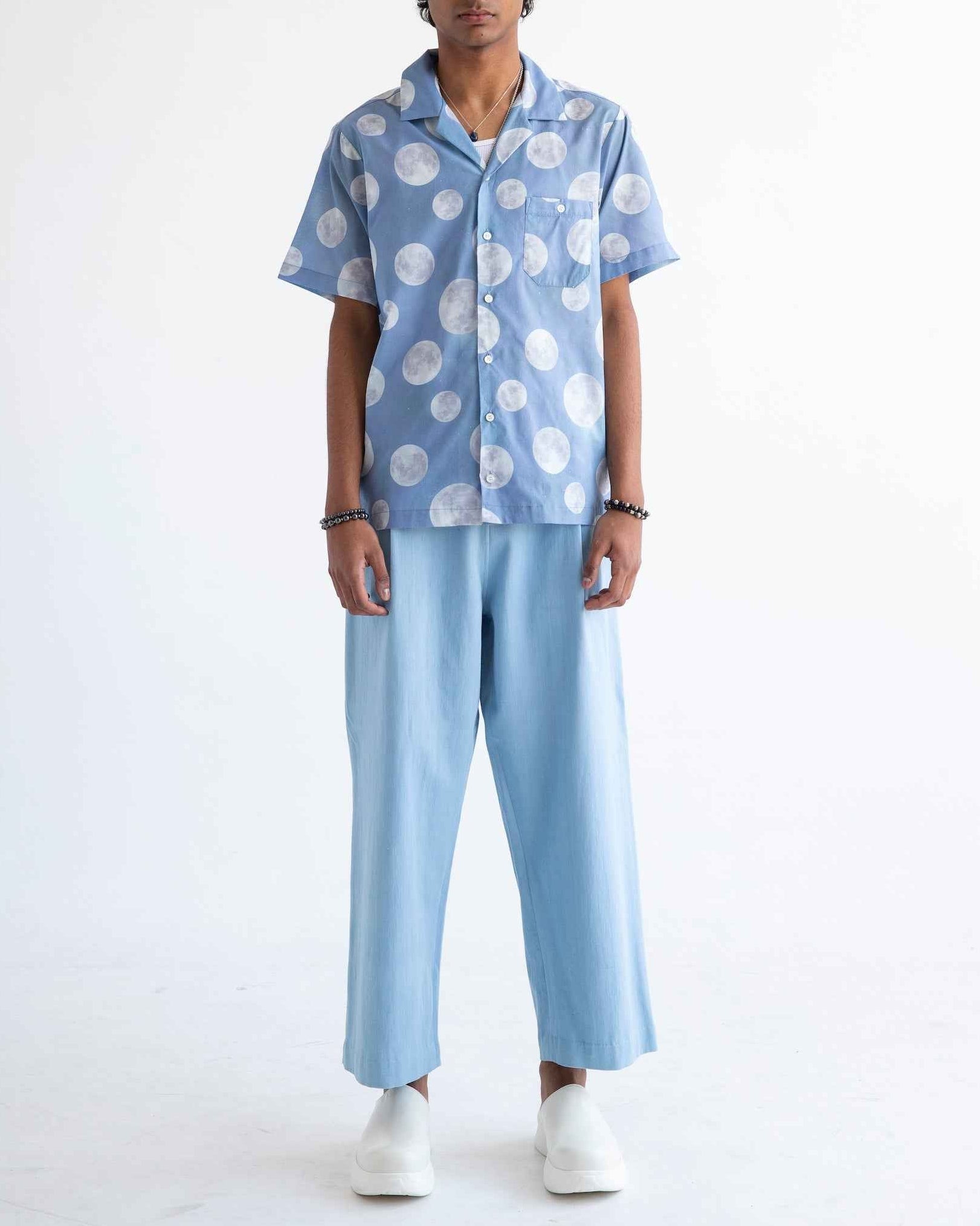 Desi short sleeve resort shirt in blue Daytime Moon print, Cuban collar, lightweight cotton voile, relaxed fit with side slits.