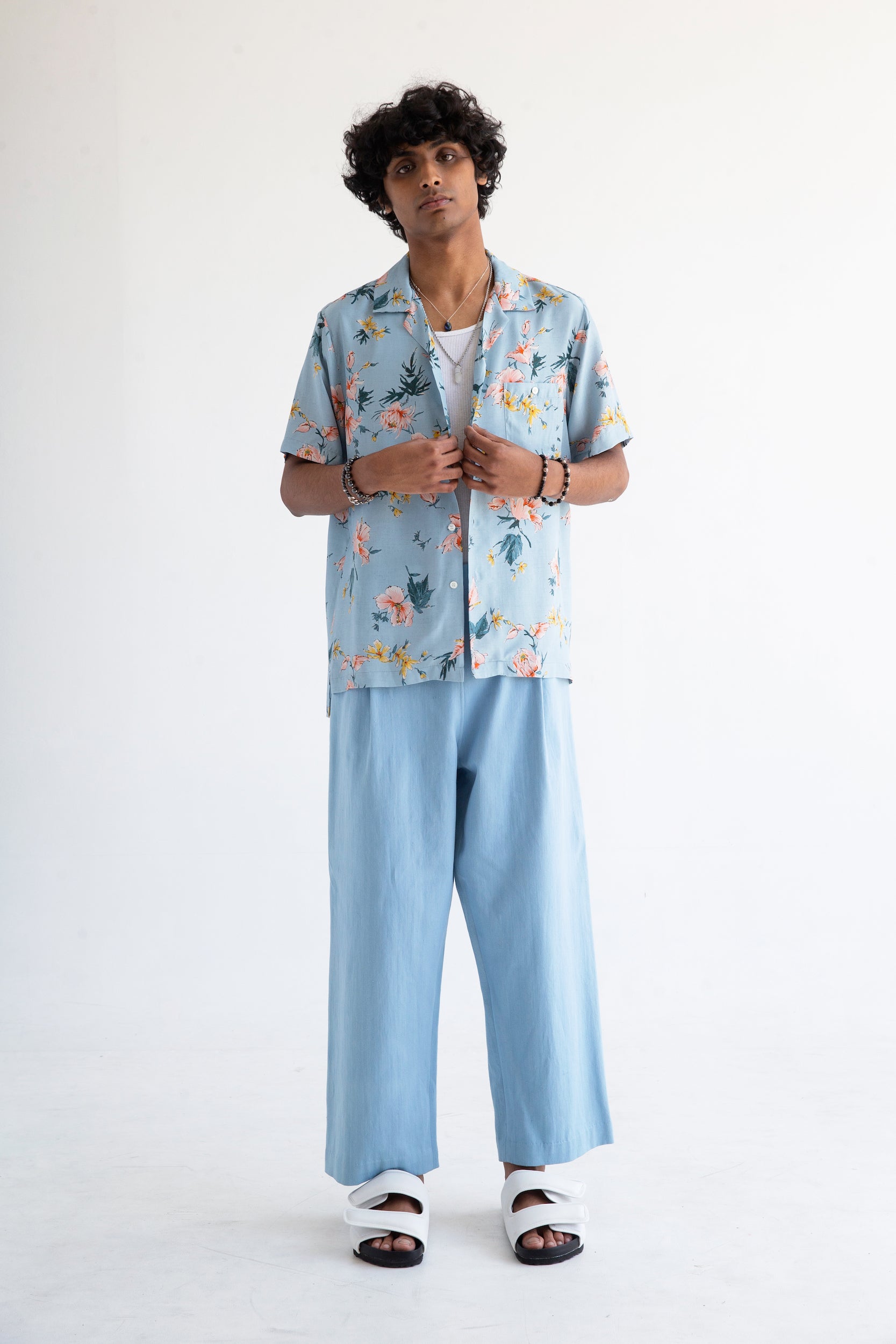 light blue hibiscus print shirt over light blue pants