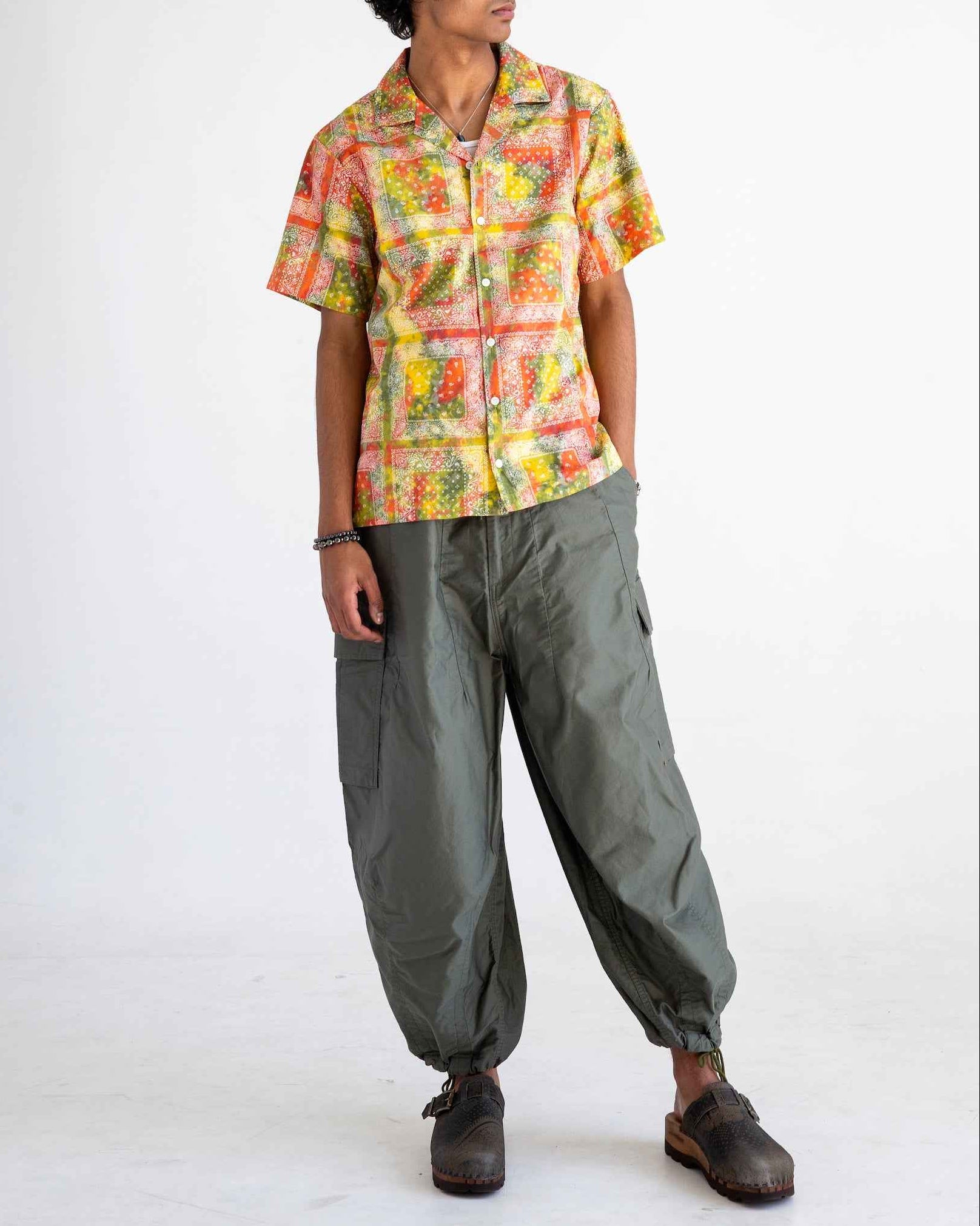 Desi short sleeve resort shirt in red batik bandana print, organic cotton poplin, Cuban collar with side slits, relaxed fit.