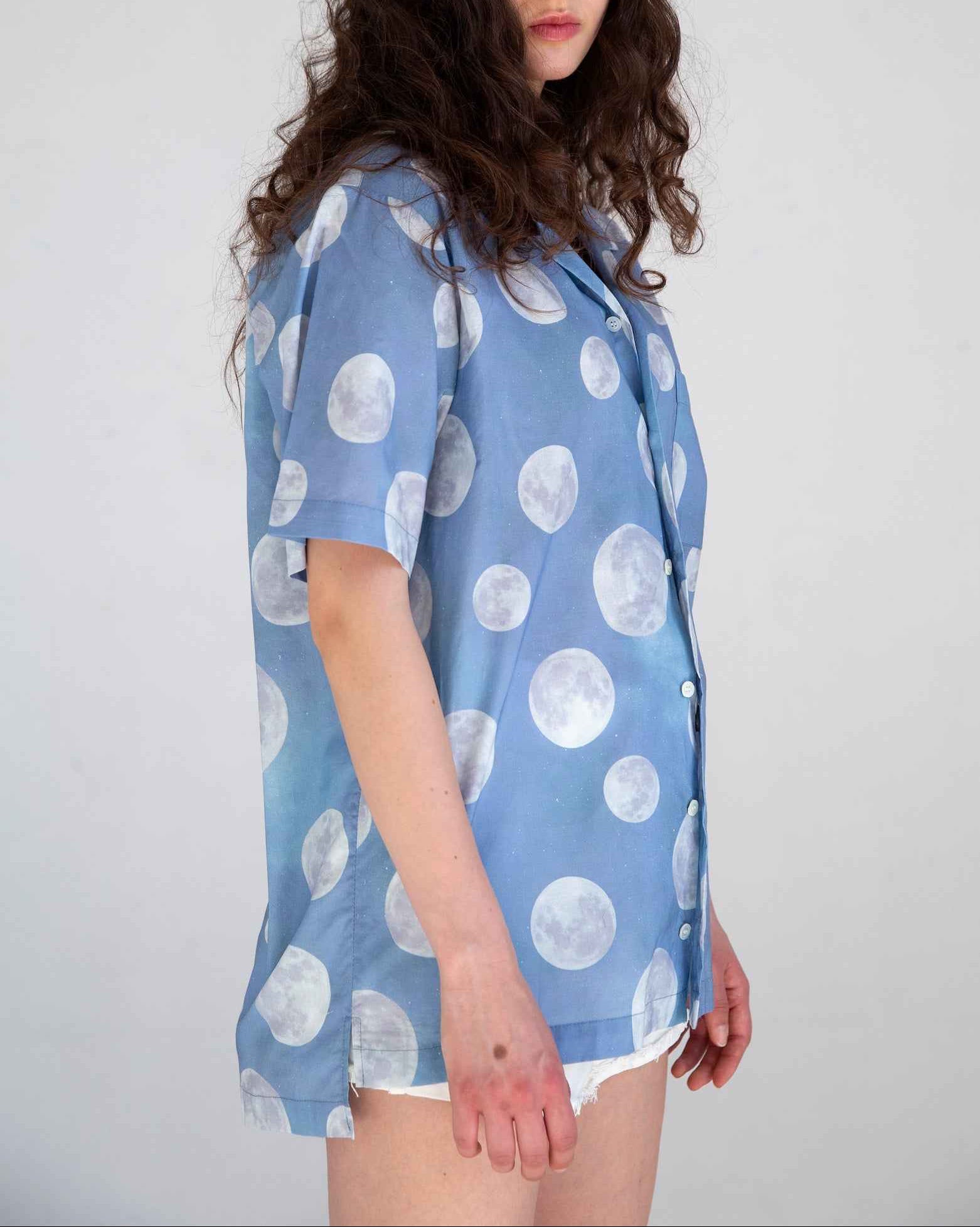Desi short sleeve resort shirt in blue Daytime Moon print, Cuban collar, lightweight cotton voile, relaxed fit with side slits.