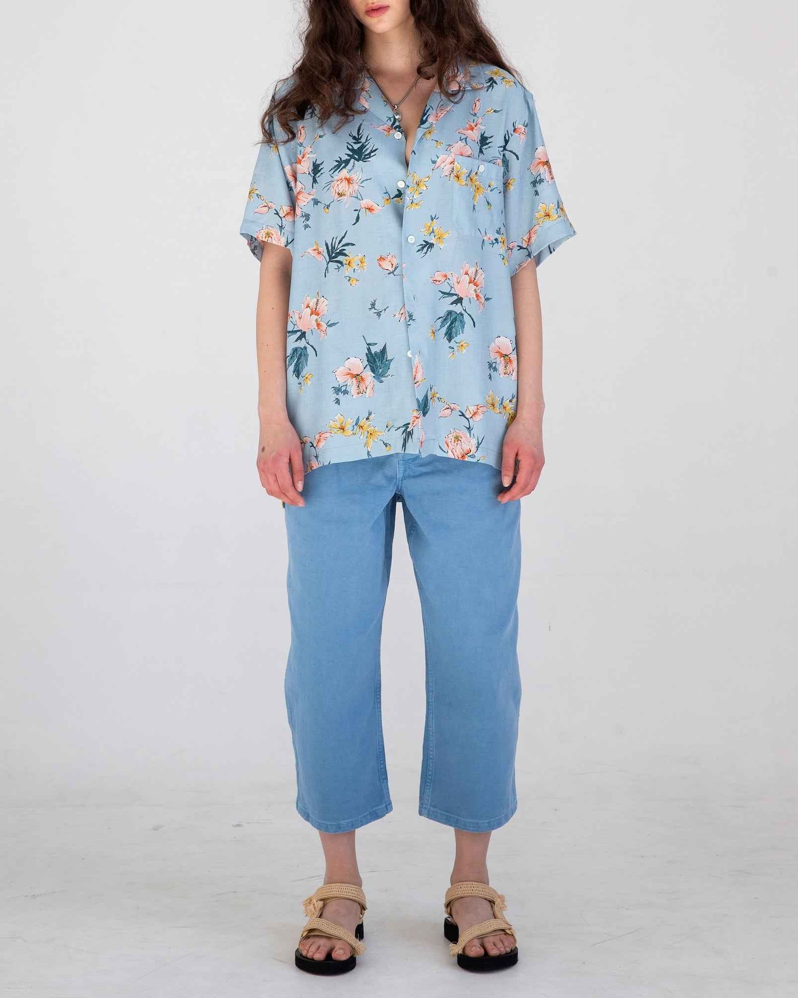 Desi short sleeve camp collar resort shirt in light blue Ukiyoe hibiscus floral print, rayon poplin fabric, shown on model.