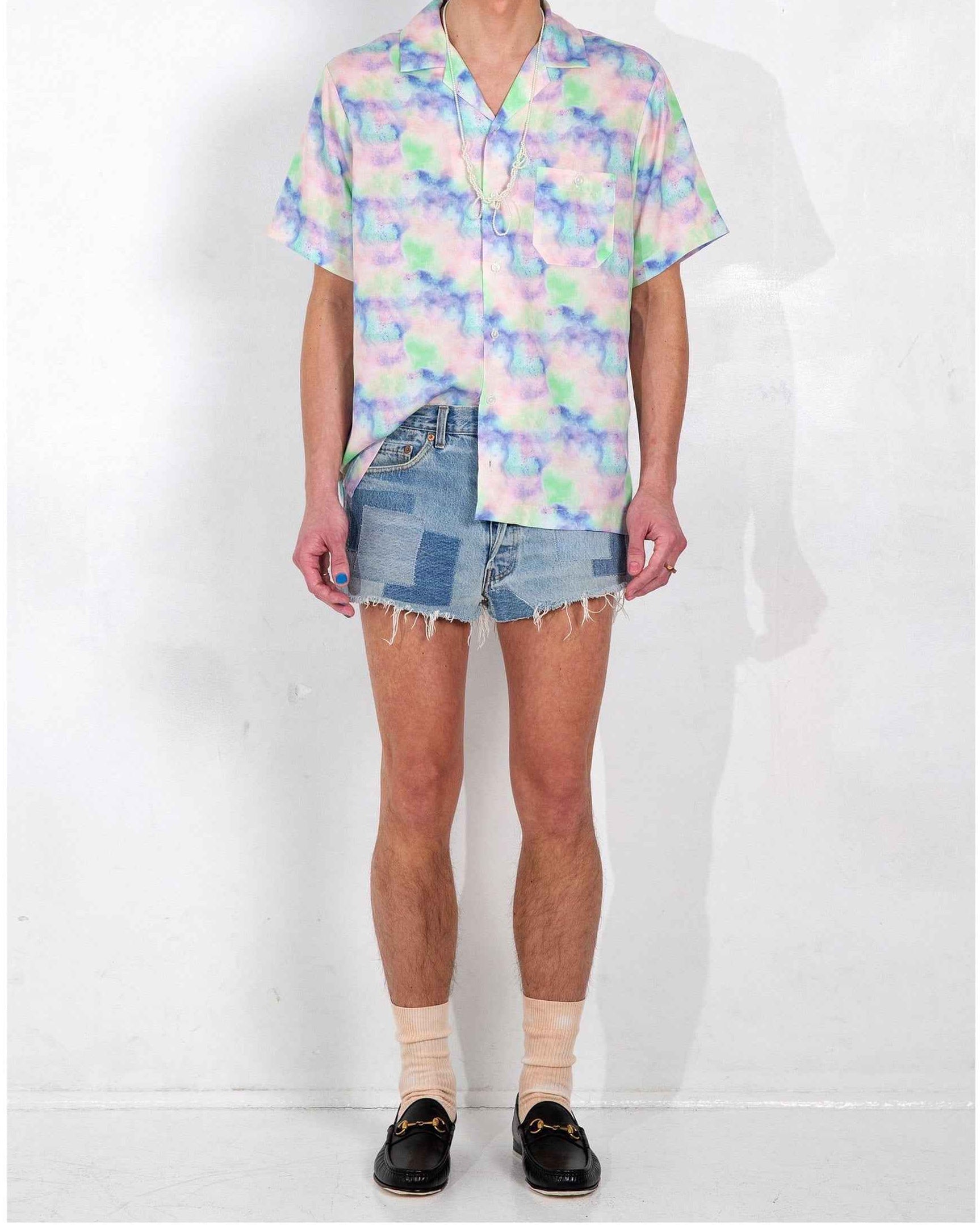 Desi Camp Collar shirt in Blue Dream Pop Print worn untucked, showing relaxed resort fit and vibrant print on lightweight cotton Tencel fabric.