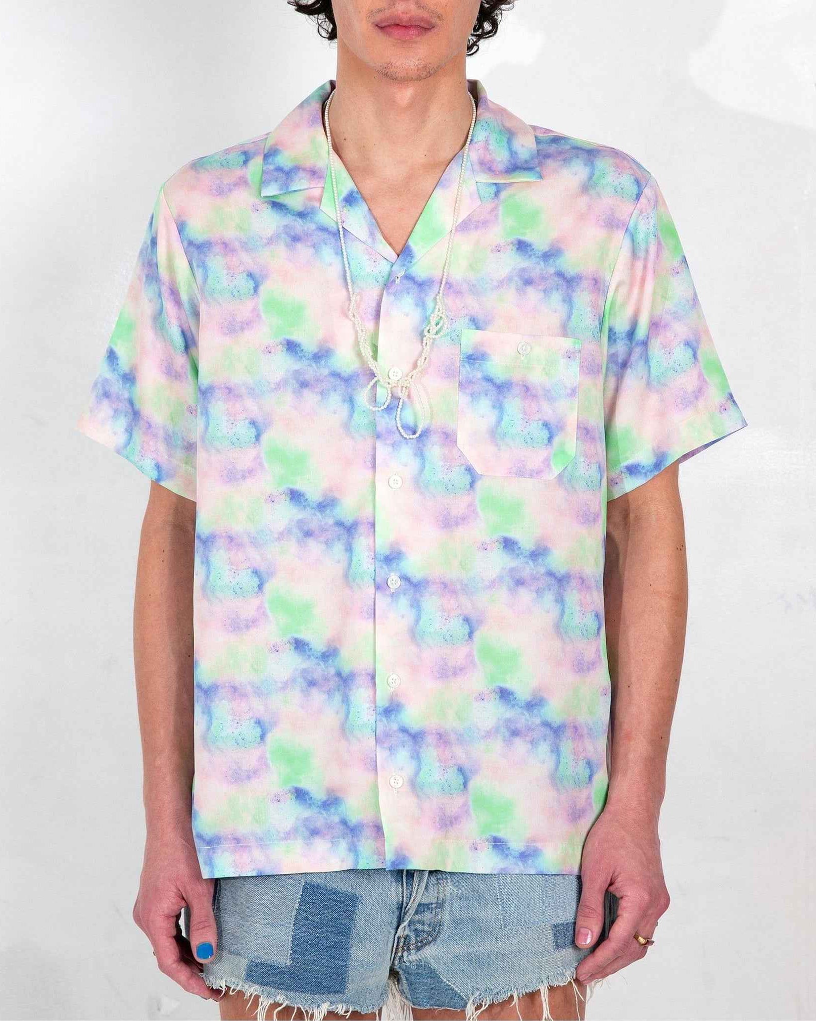 Desi camp collar shirt in blue dream pop print, relaxed resort fit, short sleeves, worn untucked on model.