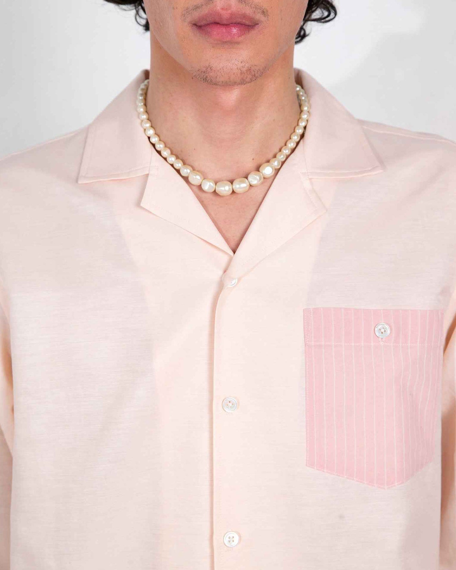 Arenas blush and white striped long-sleeve shirt with convertible collar on model, showing relaxed fit cotton linen cupro fabric.