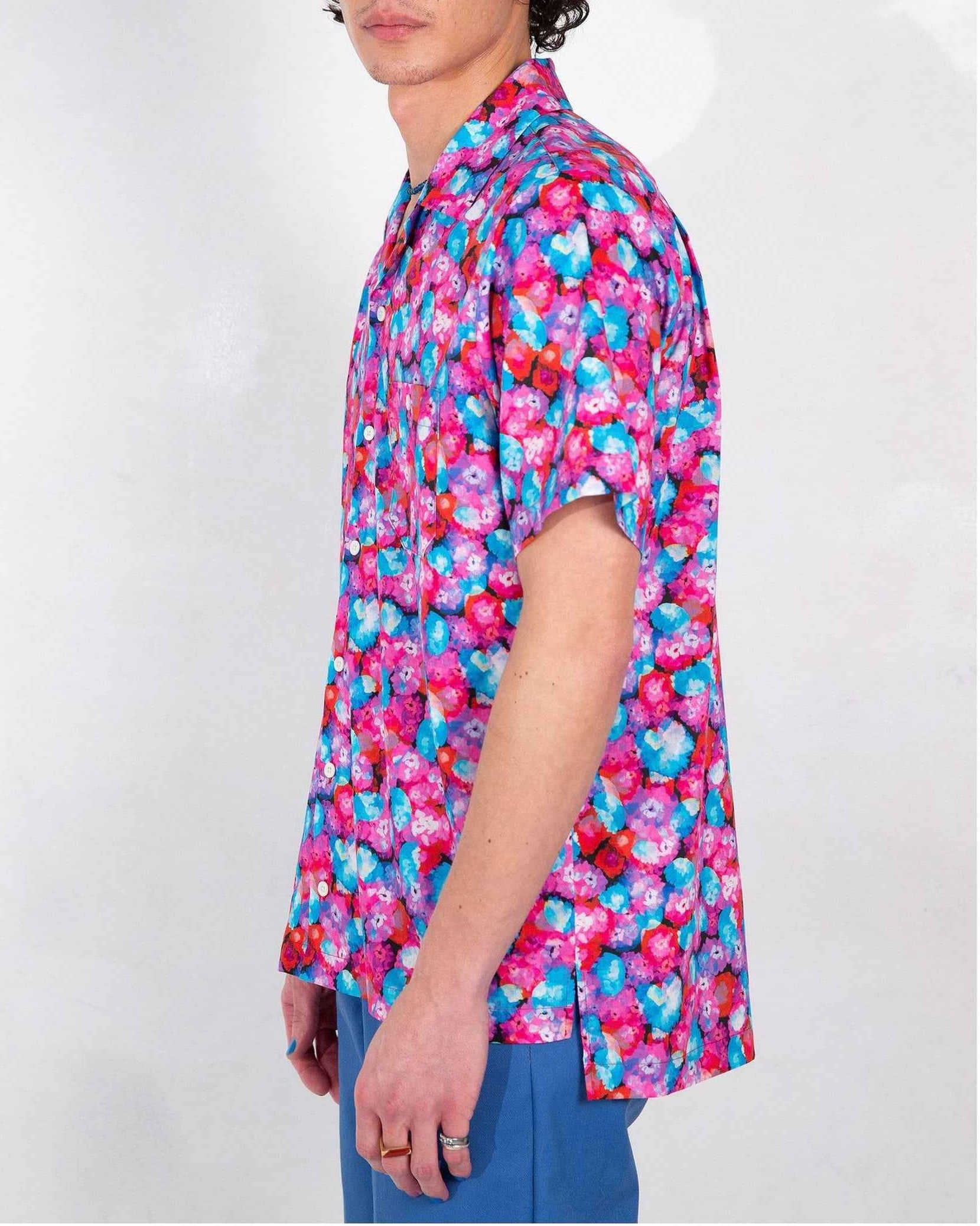 Desi camp collar shirt in red floral dream print, soft cotton and Tencel twill, relaxed fit with side slits, worn by model in medium.