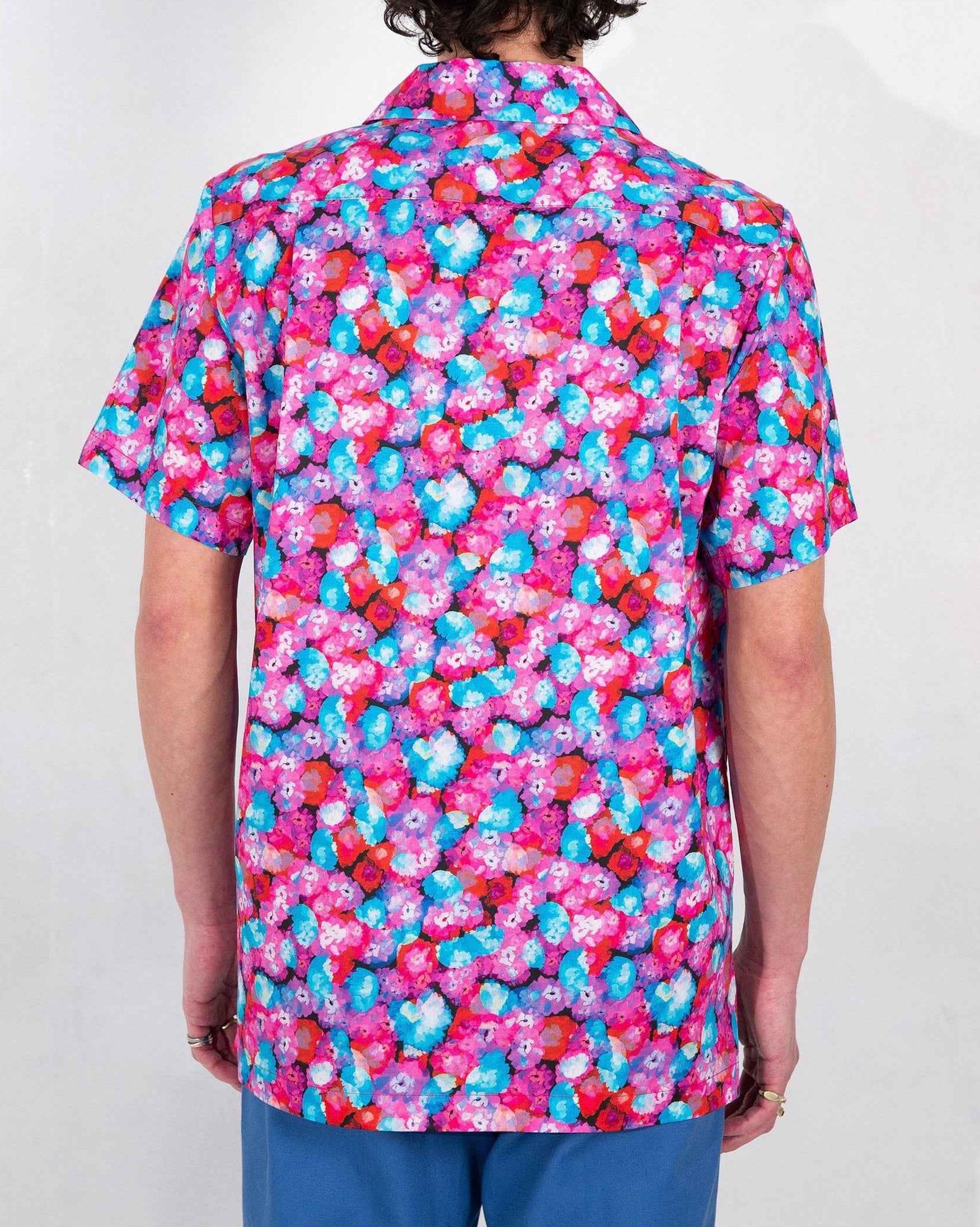 Desi camp collar shirt in red floral dream print, soft cotton-Tencel twill, relaxed fit with side slits, shown on model in medium.