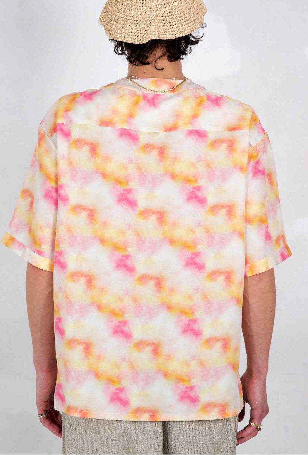Valenzuela baseball collar shirt in red Dream Pop swirl print, relaxed boxy fit with side slits, worn by model in neutral pose.